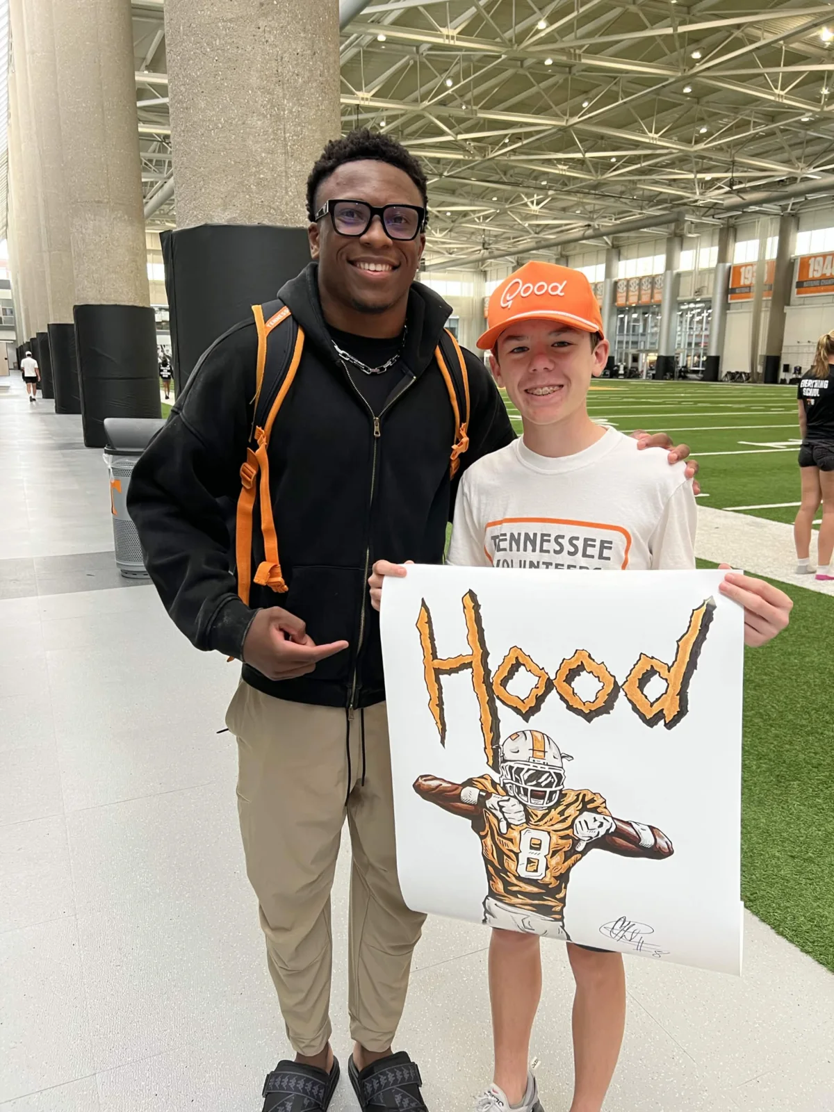 A completed custom sports drawing being held in person